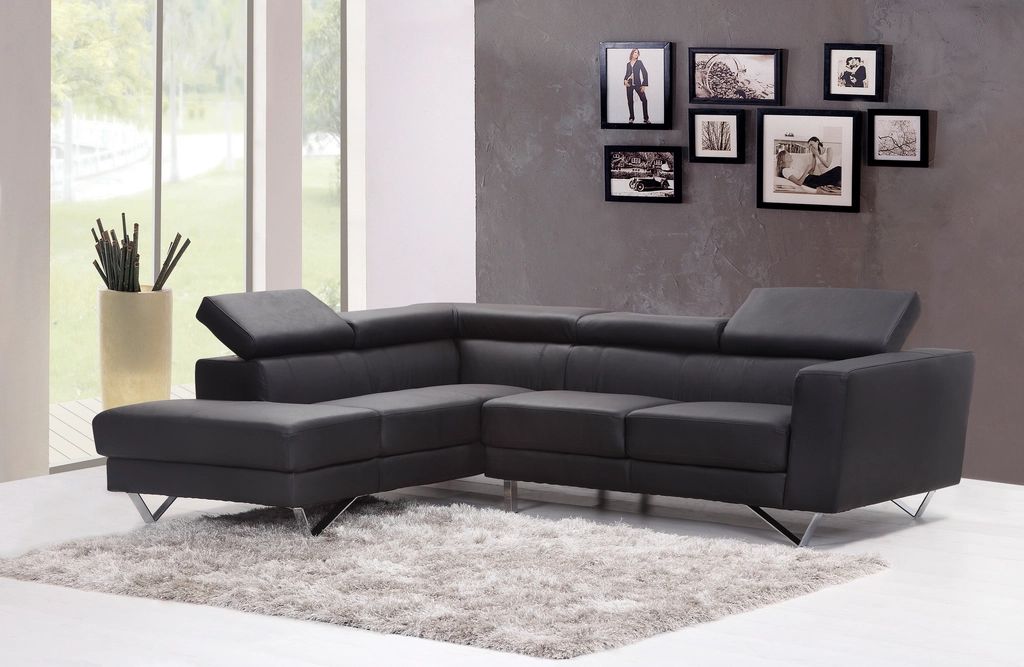 Elegant living room with a dark sectional sofa and gallery wall
