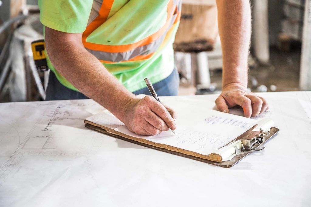 Person reviewing a checklist on a clipboard before a project