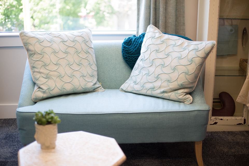Cosy sofa corner with cushions near a window