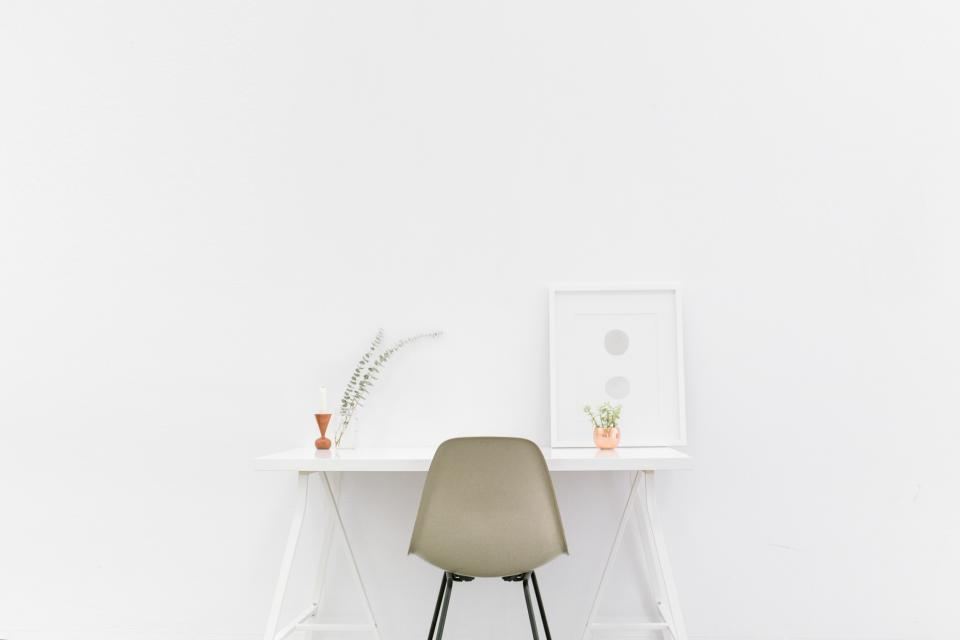Minimal desk and chair in a white design studio