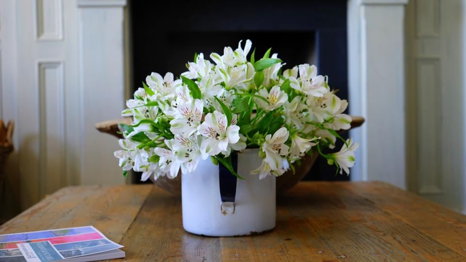Simple table with a vase of white flowers
