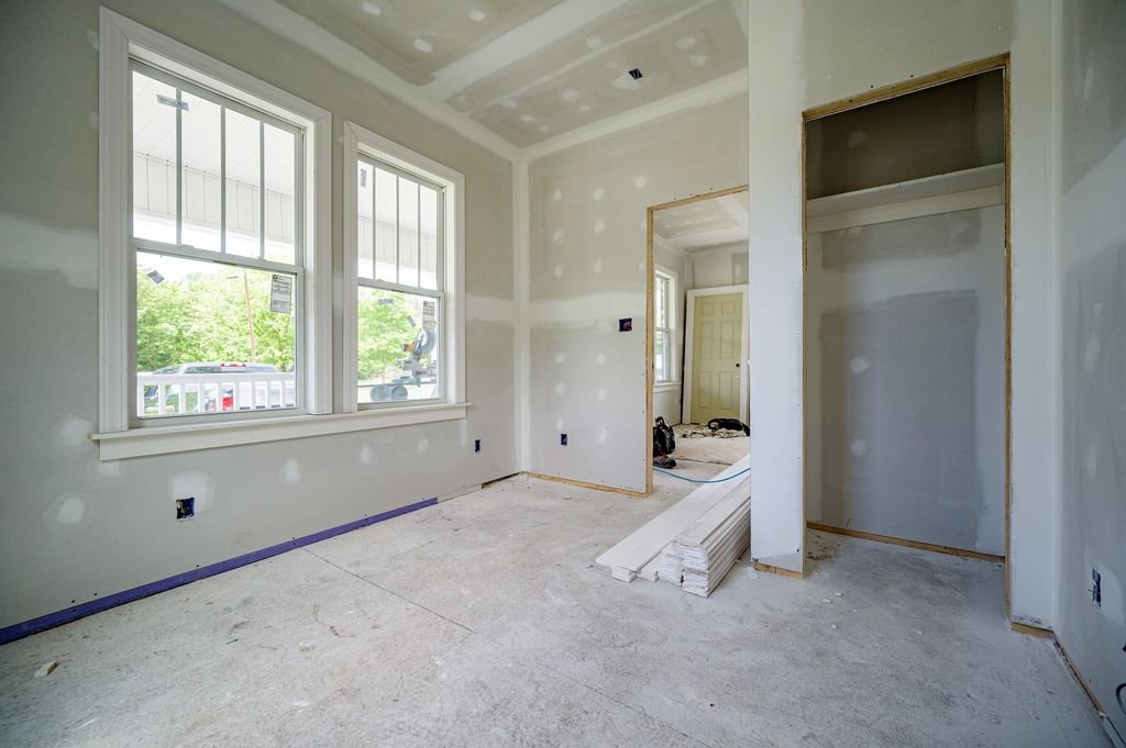 Empty room being renovated with fresh walls and floor