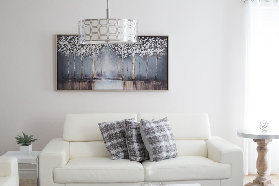Bright living room with white sofas and soft daylight