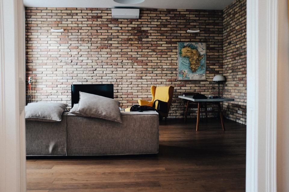 Bright open-plan apartment with a living area, dining table and large windows