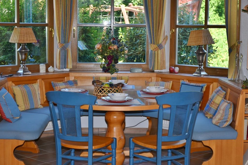 Cosy dining nook with built-in bench seating and blue chairs