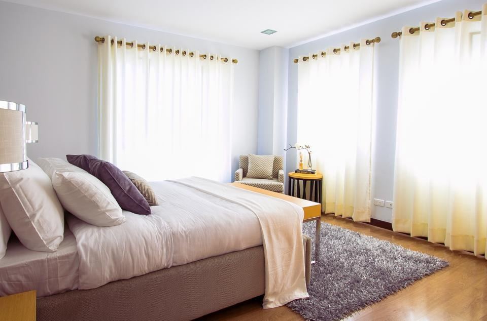 Serene bedroom with soft bedding and sheer curtains