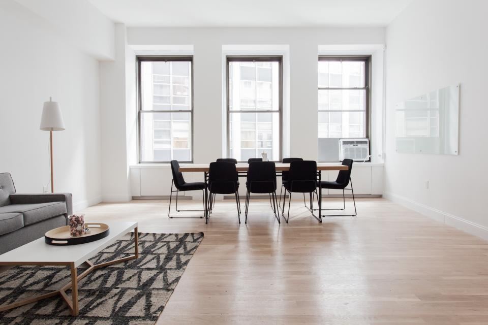 Minimal open-plan living and dining area with large windows