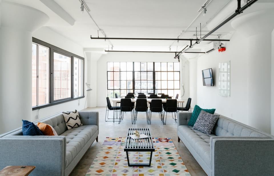 Spacious apartment living room with long sofas and a patterned rug