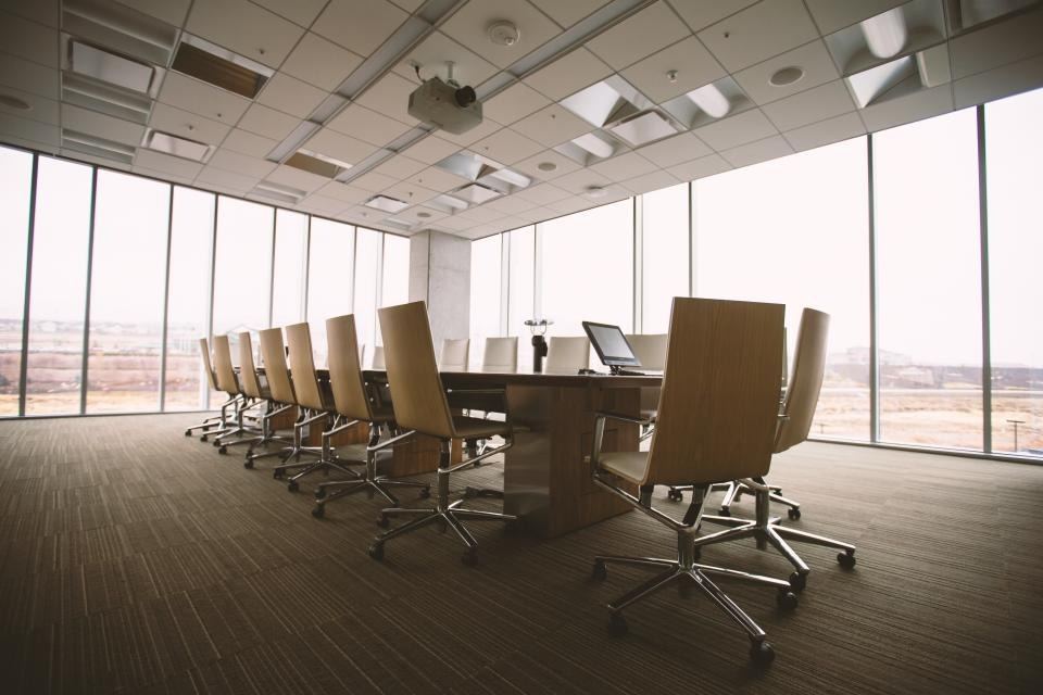 Modern conference room with glass walls and a long meeting table