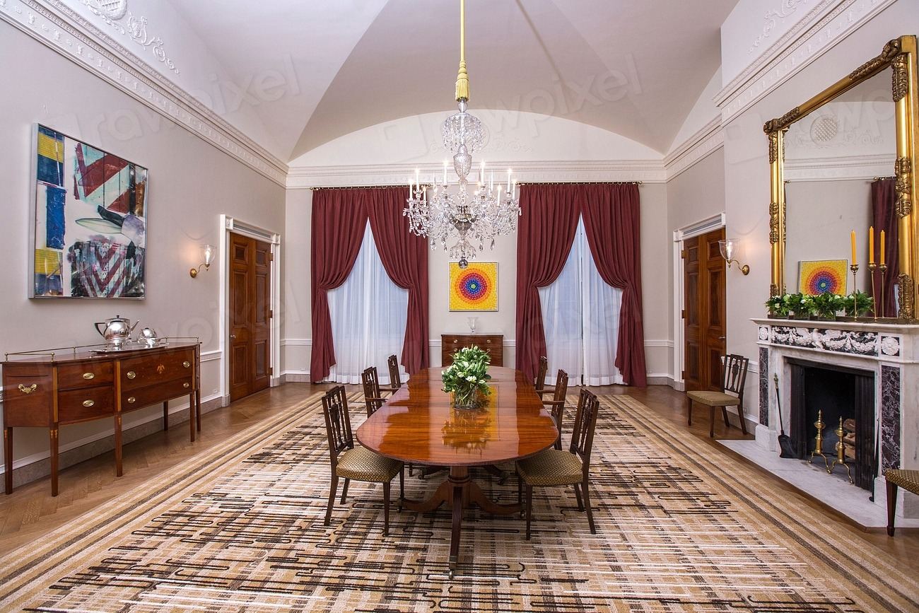 Formal dining room with a chandelier, rich drapes and classic furniture