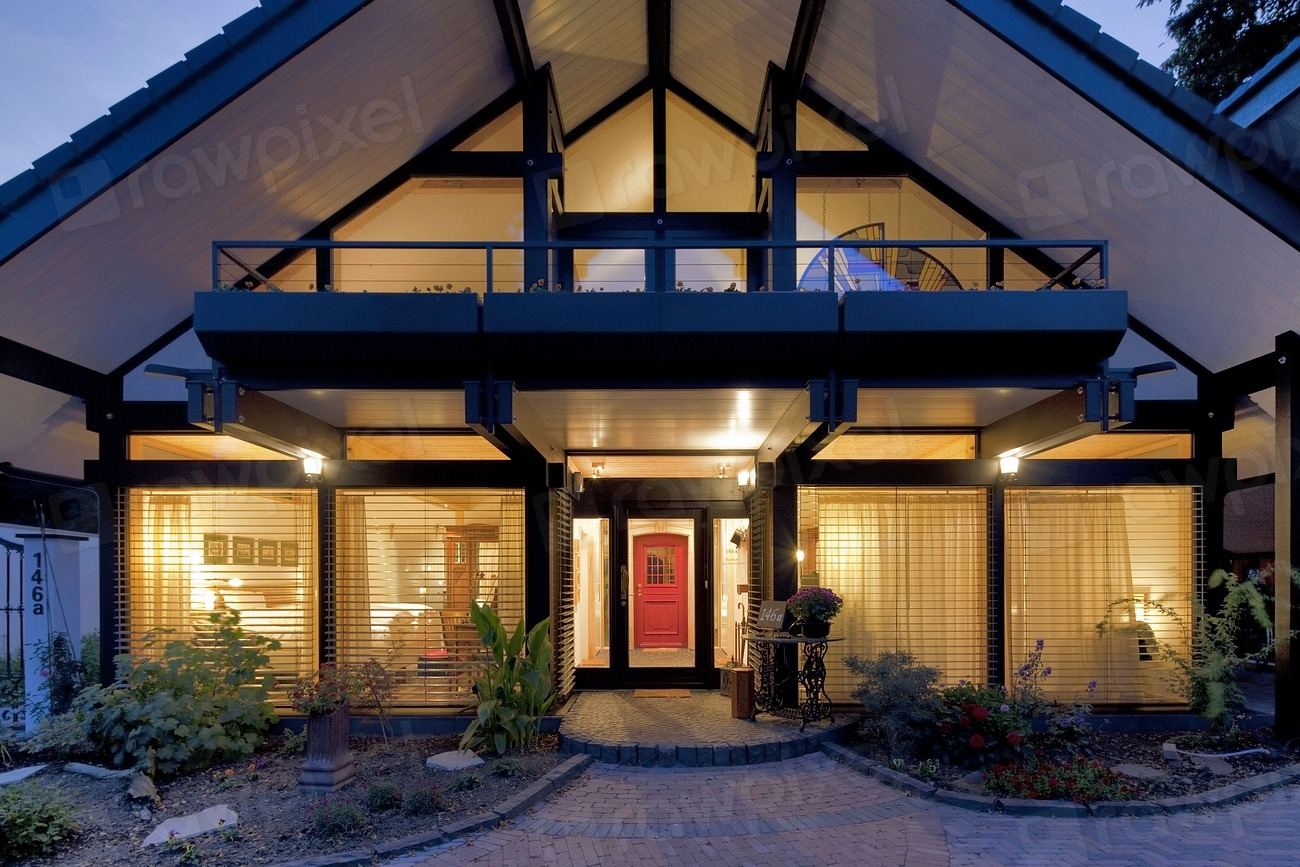 Two-storey family home with warm lights glowing at dusk